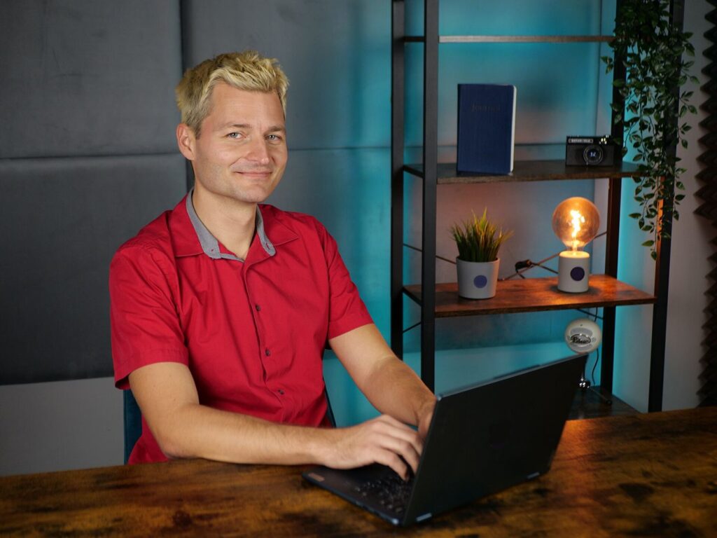 A video creator's desk with camera, microphone and editing screens