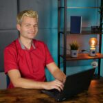 A video creator's desk with camera, microphone and editing screens